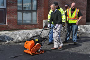 Mayor Jorge Elorza repairing potholes.