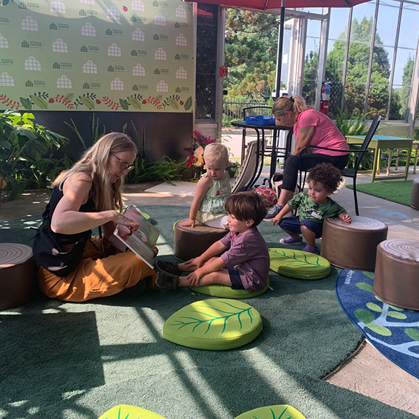 Photo of an adult reading a book to a child