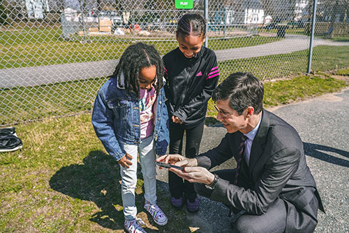 photo of mayor smiley interacting with 2 children - link opens to binformation about engagement efforts