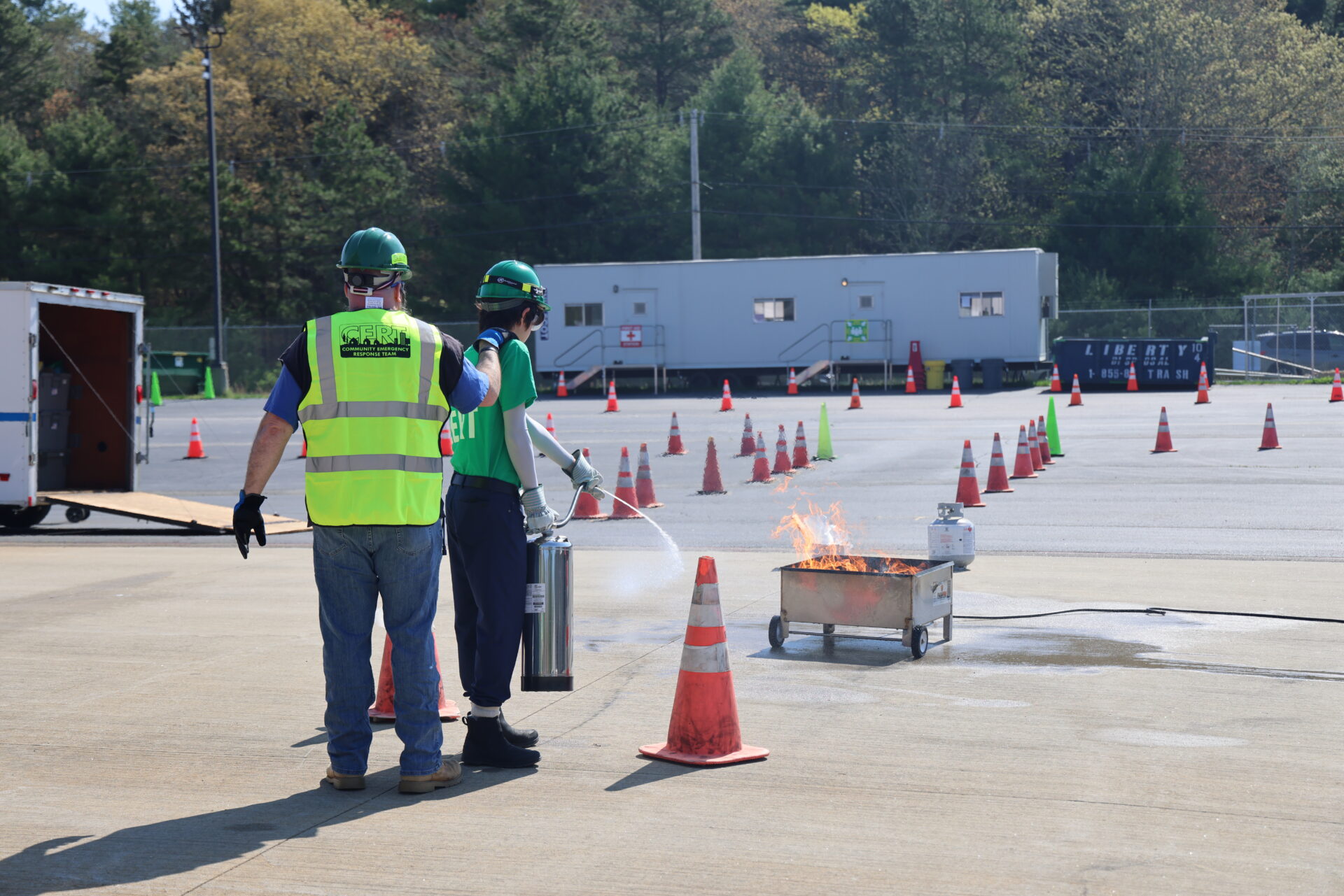 Photo of two volunteers training with a fire extinguisher