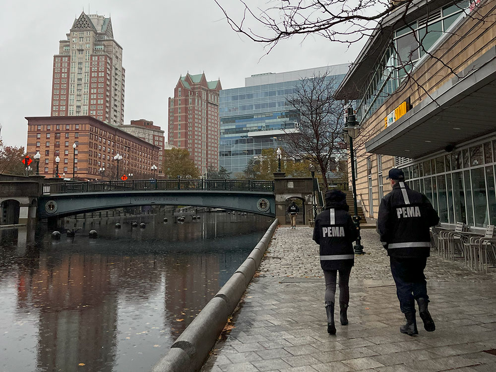 Photo of people wearing PEMA Jackets walking through Waterplace Park