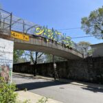 photo of a walking bridge with art work on the side