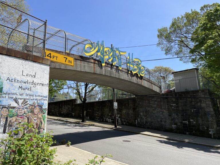 photo of a walking bridge with art work on the side