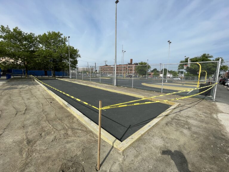 photo showing renovation work with basketball courts in the background