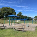 Hopkins Park playground benches from the parking lot