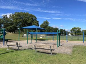 Hopkins Park playground benches from the parking lot