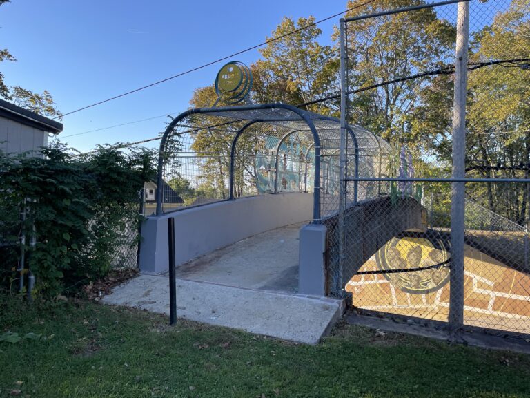 photo showing the entrance to a walking bridge over a roadway