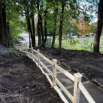 photo showing a walking path with steps and a handrail