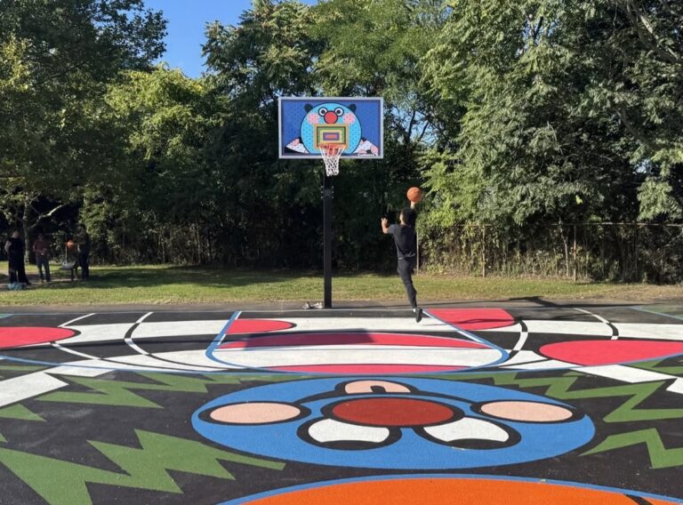 photo of a person playing backetball on a colorful basketball court