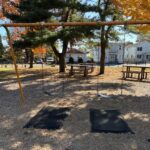 photo showing swing set and picnic tables