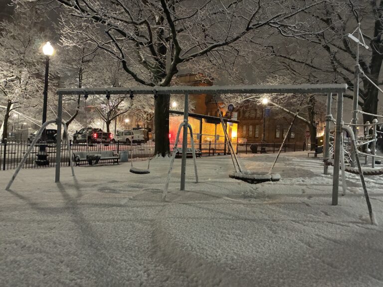 photo showing snow that had recently fallen on the playground at Burnside park at night