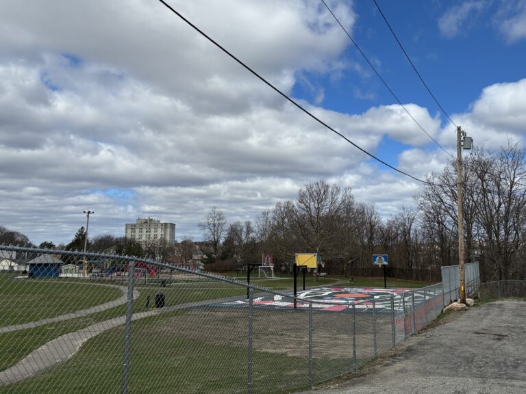 photo showing a park with walking paths and a basketball court