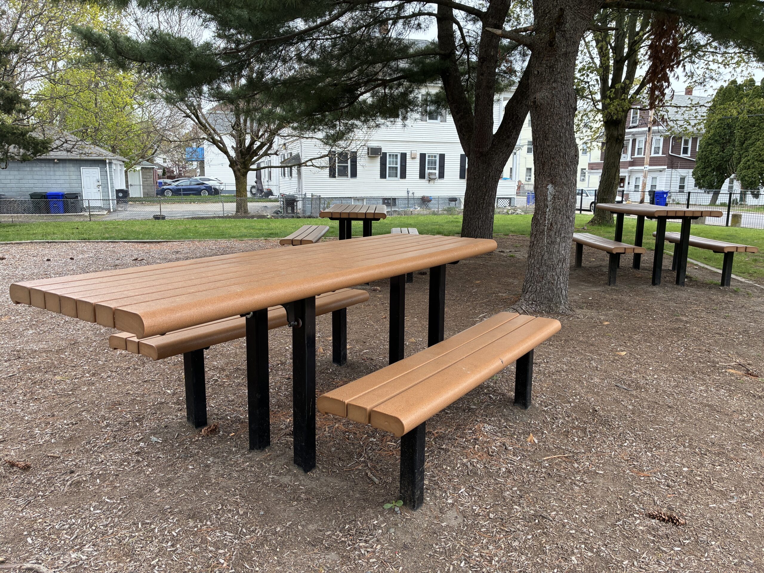 photo showing trees and picnic tables