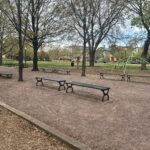 photo showing park benches and playground structures