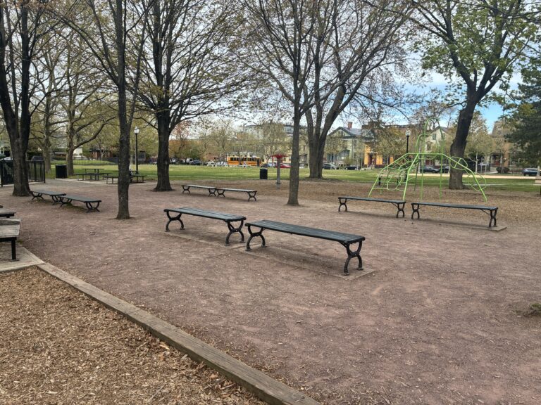 photo showing park benches and playground structures