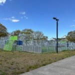 photo of a fence surrounding a turf sports field