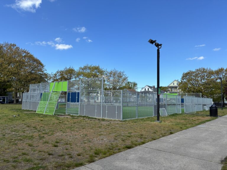 photo of a fence surrounding a turf sports field