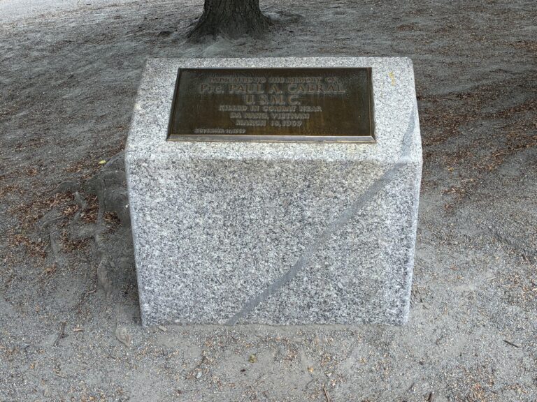 a photo showing a memorial plaque for Paul Cabral