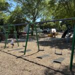photo showing swings and playground structures