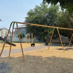 photo showing swings and slides