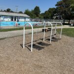 photo showing swings with a pool in the background