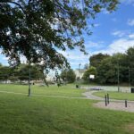 photo showing grassy fields and basketball court
