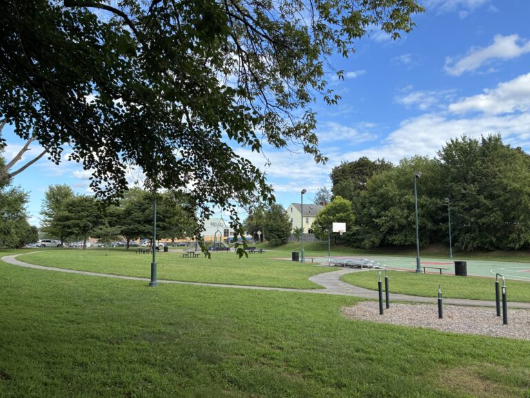 photo showing grassy fields and basketball court