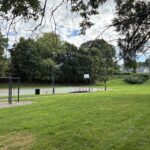 photo showing grassy fields and basketball court