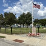 photo showing a USA flag on a flag pole at Paul Grande Park