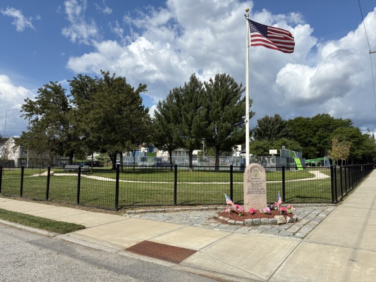 photo showing a USA flag on a flag pole at Paul Grande Park