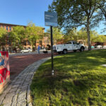 photo of cars parked on a street and a sign for Biltmore Park