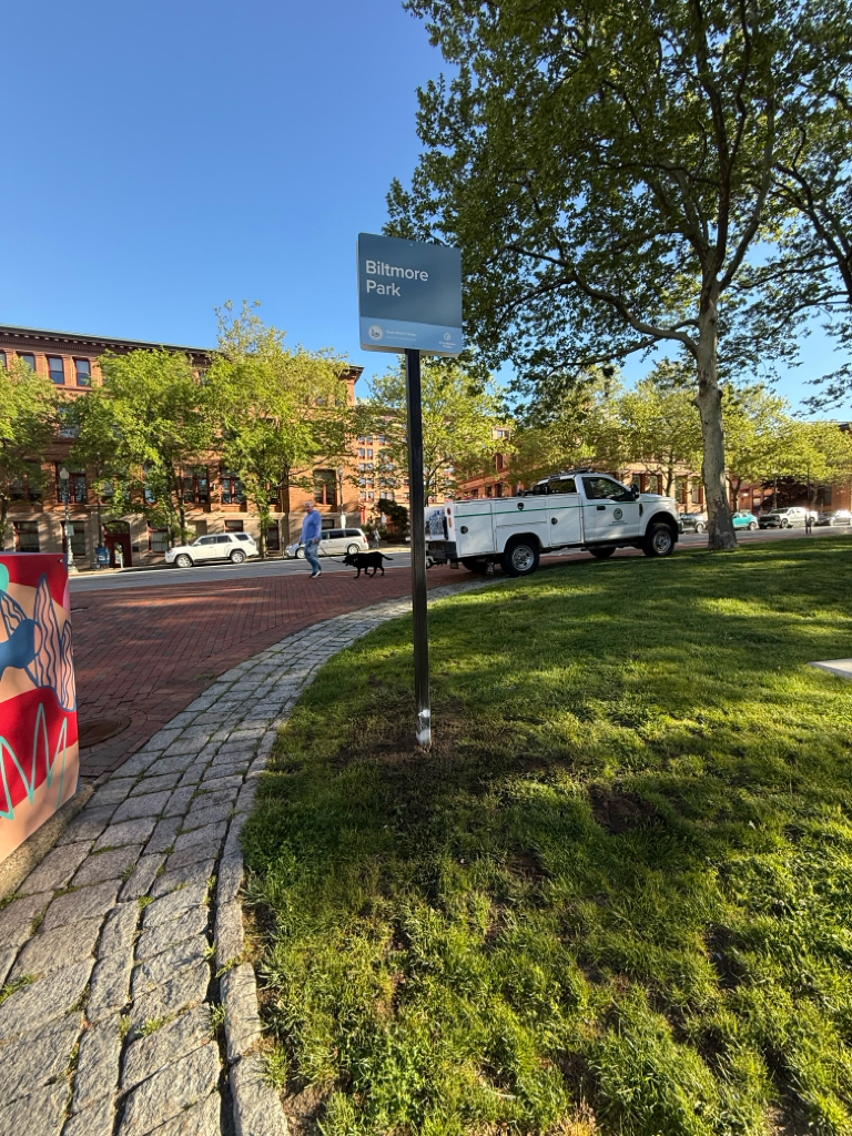photo of cars parked on a street and a sign for Biltmore Park