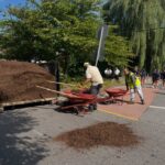 Parks Crew leading volunteers on Pleasant Valley Parkway, unloading landscape mulch