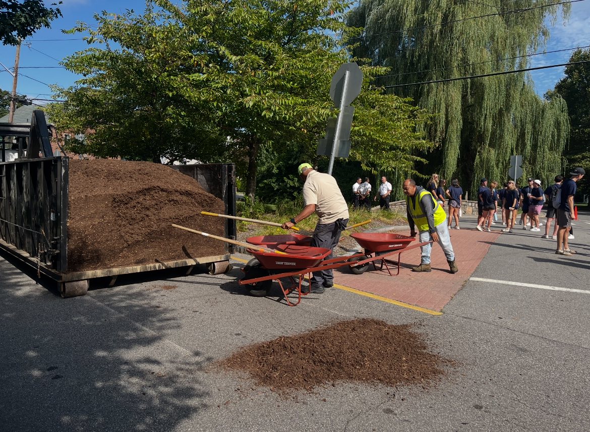 Parks Crew leading volunteers on Pleasant Valley Parkway, unloading landscape mulch