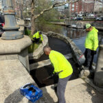 Parks Maintenance crew sealcoating walkway at Waterplace Park
