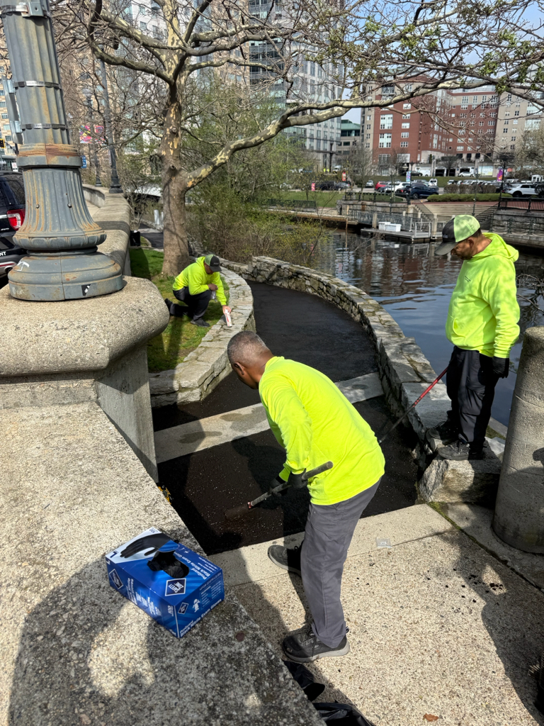 Parks Maintenance crew sealcoating walkway at Waterplace Park