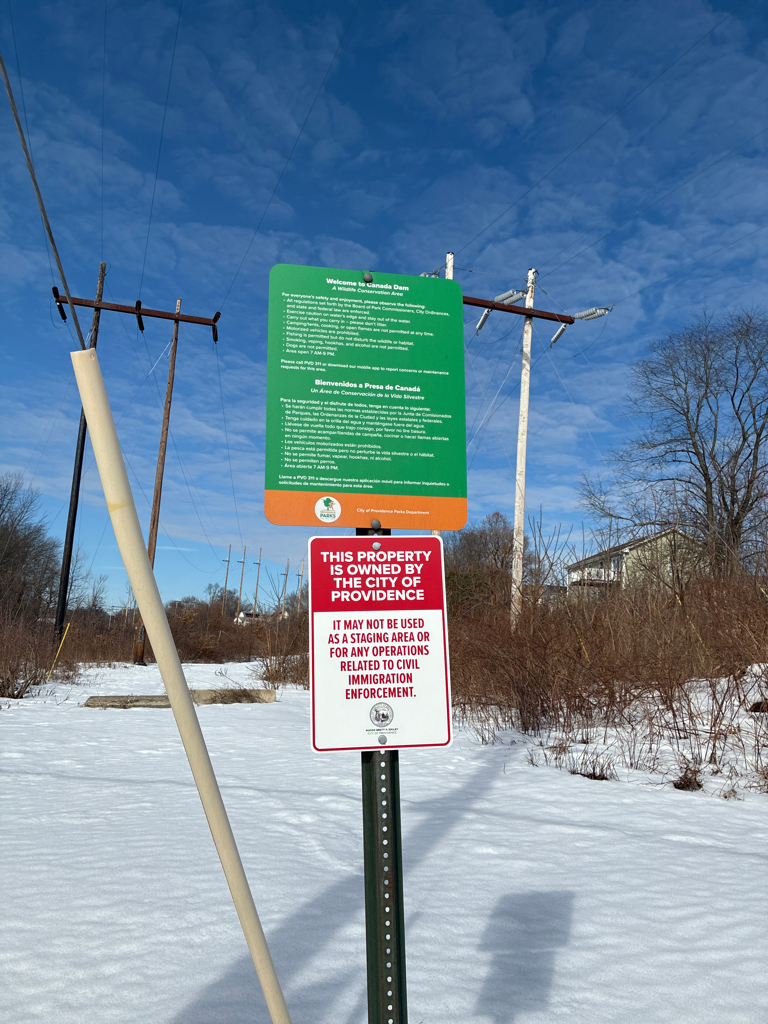 photo of power lines and a sign that says the property is owned by the City of Providence