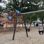 Photo showing swing set and other playground structures at Baxter Street Park