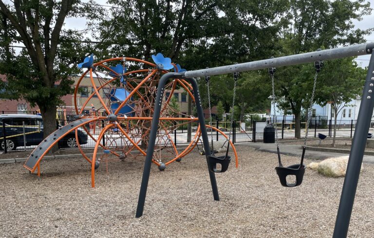Photo showing swing set and other playground structures at Baxter Street Park