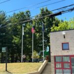 George J West Park Chalkstone Ave entrance with monument and flags