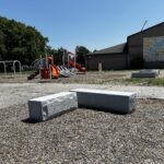 photo showing playground structures and seating areas
