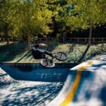 A photo of a BMX rider doing a trick on a ramp at the skate park