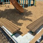 Pearl St Park seating area near playground slide