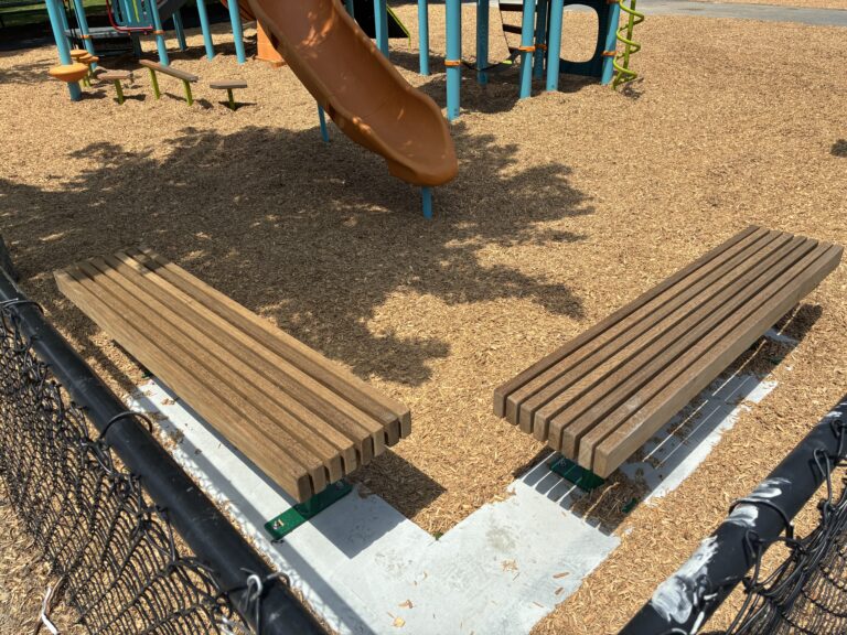 Pearl St Park seating area near playground slide