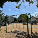 Pearl St Park swings for ages 2-12 and play structure