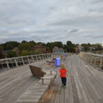 Photo of a child walking across the Michael S. Van Leesten Bridge