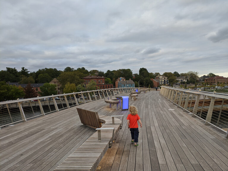 Photo of a child walking across the Michael S. Van Leesten Bridge