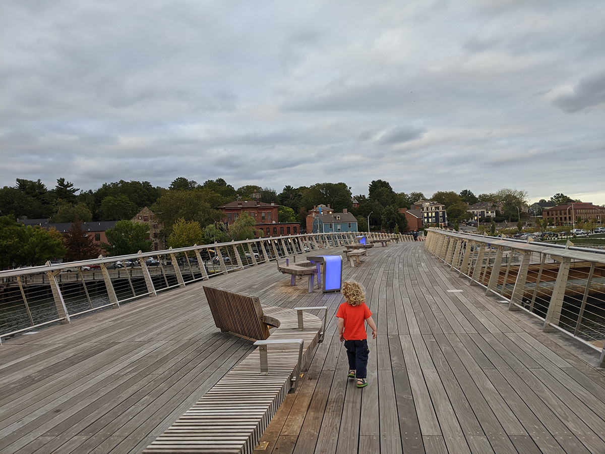 Photo of a child walking across the Michael S. Van Leesten Bridge