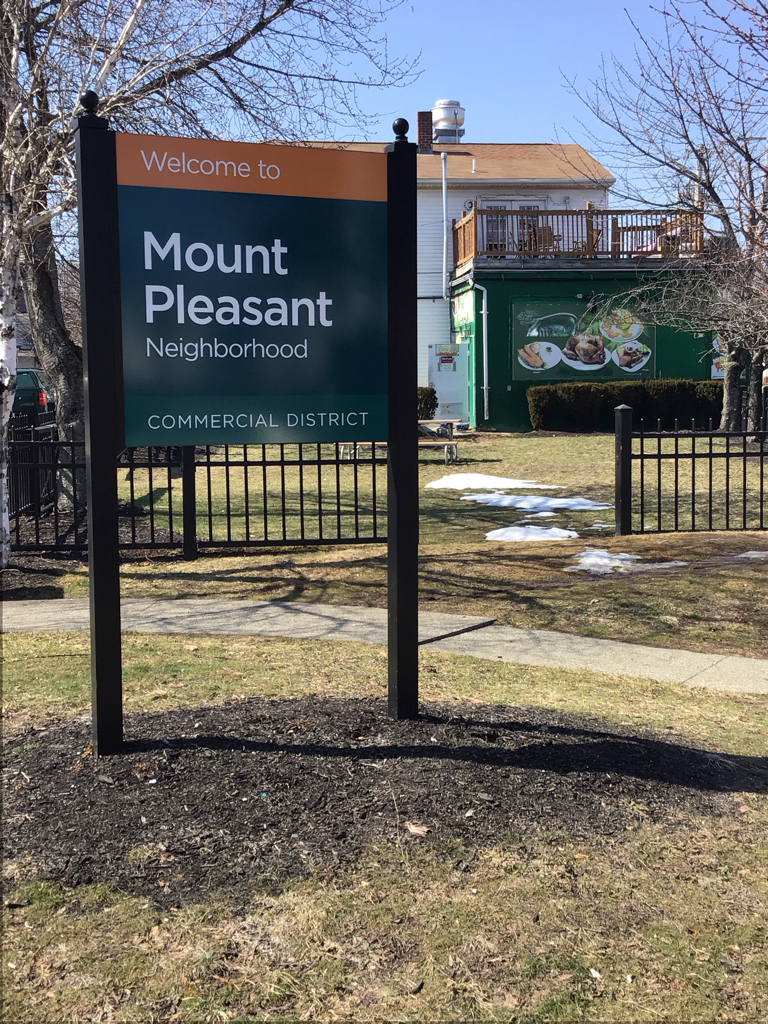 photo showing sign that reads "welcome to mount pleasant neighborhood"