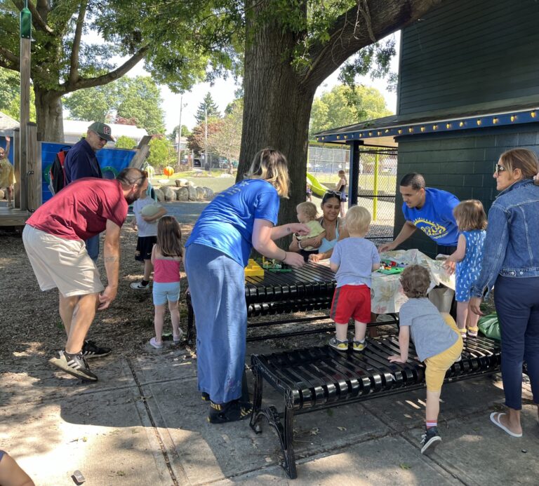 Photo of children and adults using the picnic tables at a Providence Park